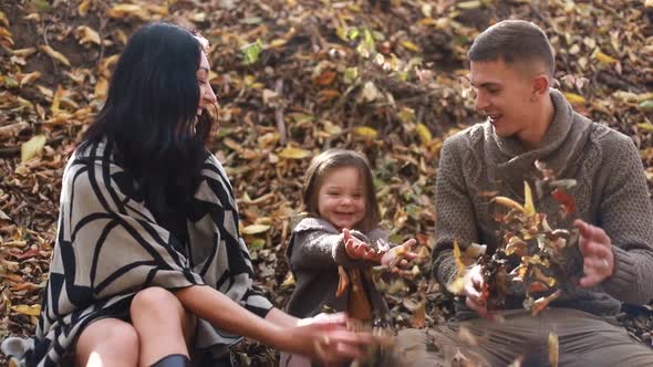 Happy young family resting in the forest