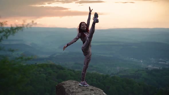 Athletic Woman Stretching Against Stunning Mountain Landscape