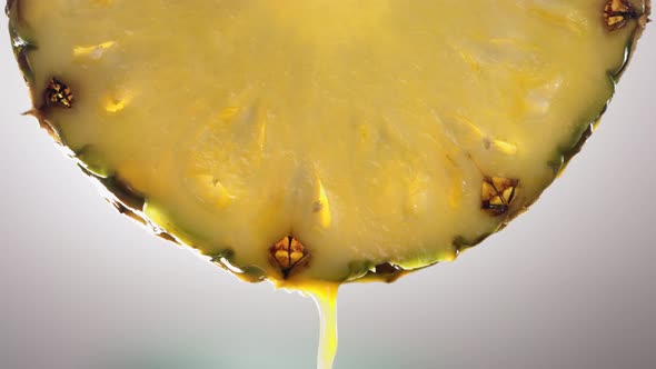 Flowing Pineapple Juice From Pineapple Slice Macro Shot in Slow Motion