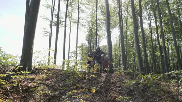 Viking warriors running in a forest