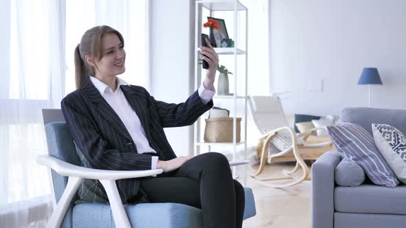 Woman in Office Taking Selfie on Smartphone