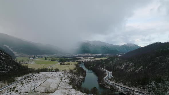 Storåna River In Årdal With Panorama of Mountains Obscure With Clouds And Fog At Winter In Norway. -