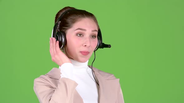 Support Worker Speaks To Customers on the Headset. Green Screen. Slow Motion
