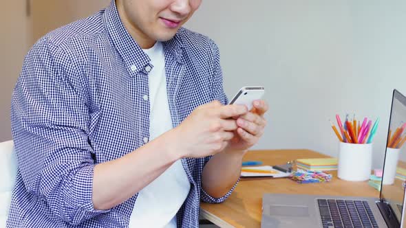 Man using mobile phone at his desk