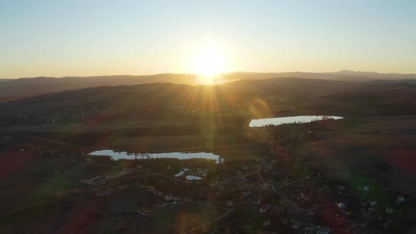 4K Aerial Drone, Flight to the Sunset over Village and Lakes