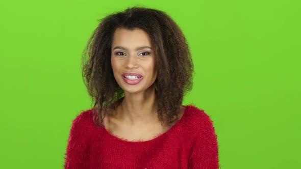 Afro American Woman Contagiously Laughs on Green Screen. Slow Motion