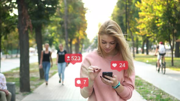 A Woman Uses a Smartphone on the Street