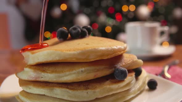 Syrup Flowing on Stack of Pancakes with Blueberry
