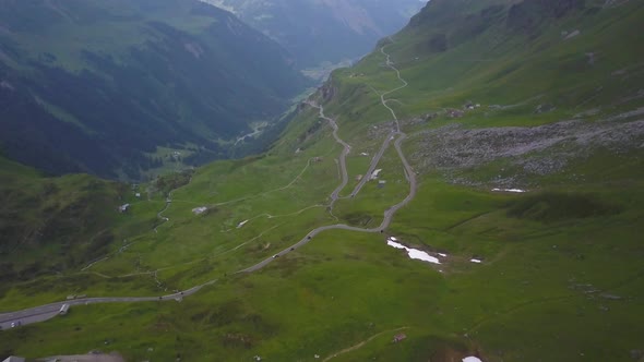 Winding road on Klausen Pass, Swiss Alps. Aerial forward