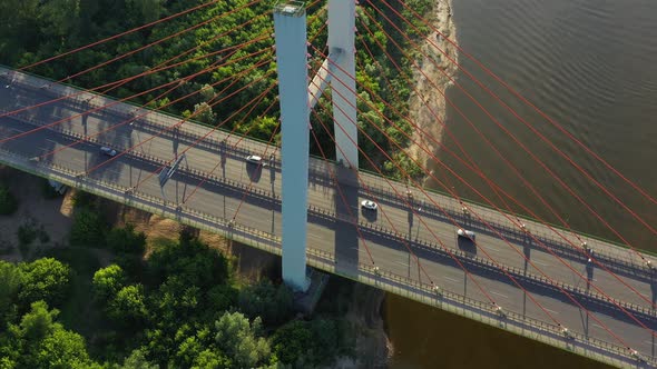 Beautiful top-down shot of traffic on modern cable stayed bridge. Rambler channel bright blue-green