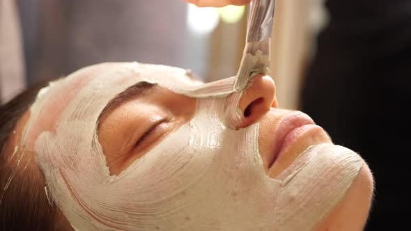 Applying a Beauty Mask on the Face with a Bone