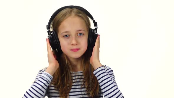 Teenager Girl Listens Music on Headphones, Shakes Head. Slow Motion