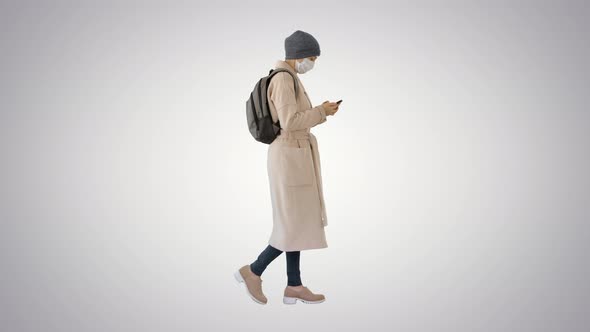 Female Wearing Medical Mask Walking on Gradient Background