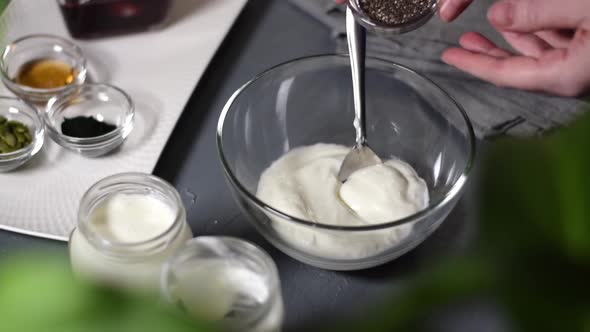 Adding chia seeds into natural yogurt