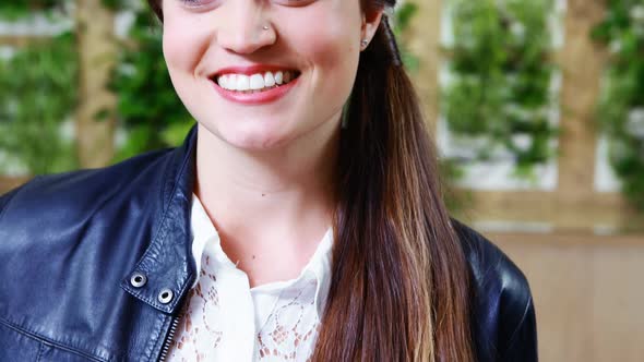 Smiling female executive standing in office