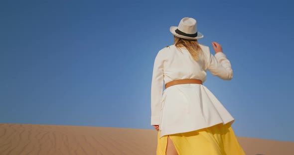 Stylish Woman Standing in Desert Landscape