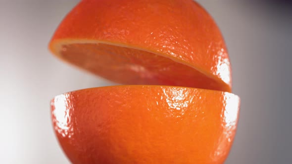 Half Orange Falling and Splashing on White Kitchen Background