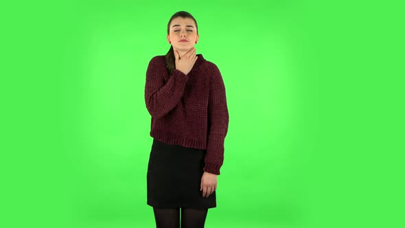 Girl Got a Cold, Sore Throat and Head, Cough on Green Screen at Studio. Green Screen