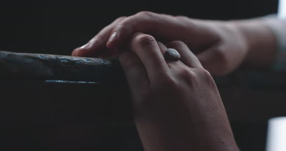 Young woman resting hands on table top close up