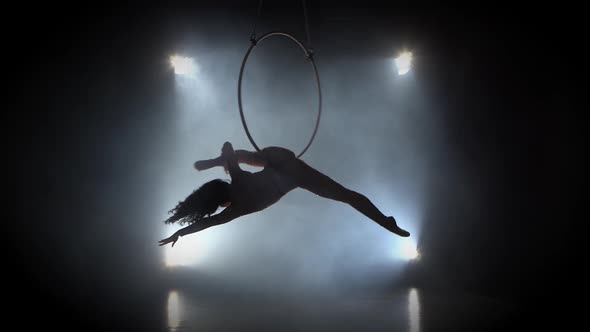 Aerial Acrobat in the Ring. A Young Girl Performs the Acrobatic Elements in the Air Ring 001