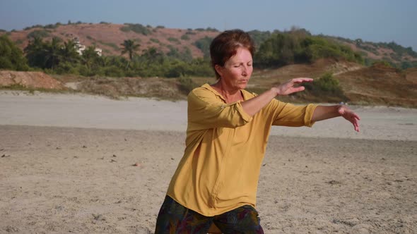 Senior Woman Practicing Taiji Gymnastic Outdoor