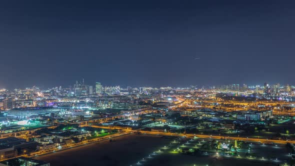 The Rhythm of the City at Night with Illuminated Road in Dubai Near Canal Aerial Timelapse