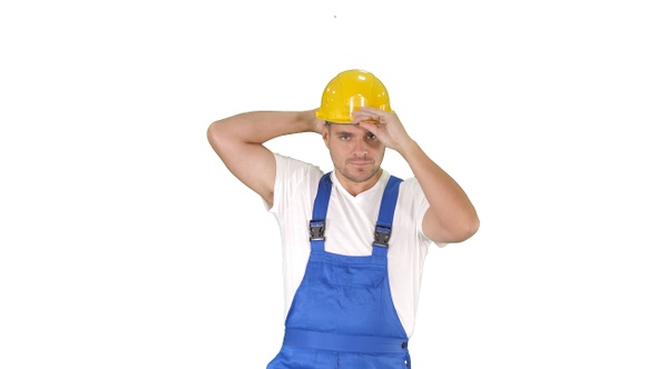 Construction worker walking and putting on hard hat or