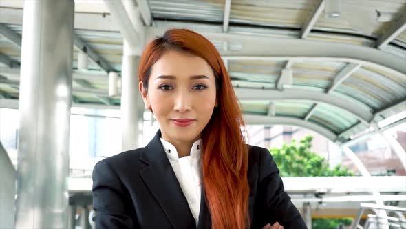 Young Beautiful Asian Business Woman Looking at the Camera with Smiley Face in Urban City