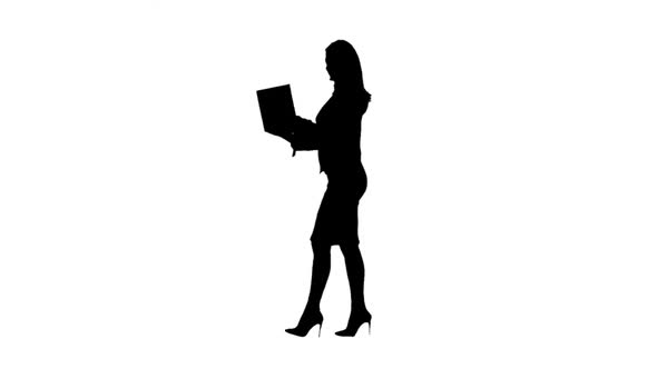 Business Woman Walks with a Laptop in Hand and Prints a Message . Side View. White Background