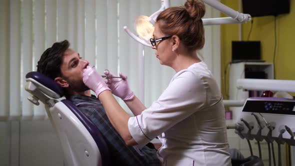 Dentist Doing Anesthesia To Patient in Office