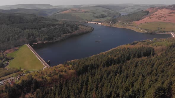 Drone travelling away from Lady Bower Reservoir Whilst panning up revealing Lady Bower Reservoir fro