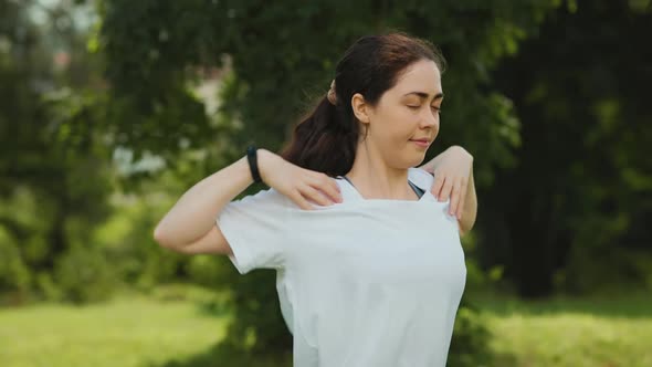 Outdoors warmup. Portrait of young beautiful woman doing warm-ups in the park. Slow motion.