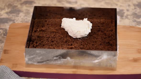 Woman Is Preparing Chocolate Cake with Milk Cream. The Process of Making the Chocolate Cake