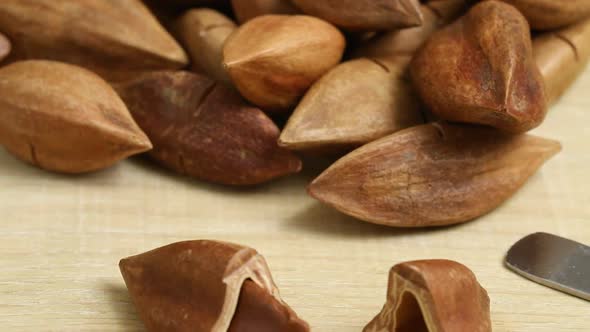 Group of  Philippines pili nuts and a broken one in front close up