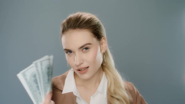 Young Business Woman Holding Cash Money. Rich Girl Hold Dollar Money Near Face