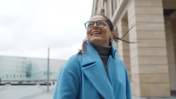 Young Businesswoman Standing Near Modern Building on City Street