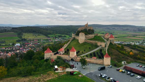 Aerial drone view of Rupea Fortress, Romania. Citadel located on a cliff, tourists