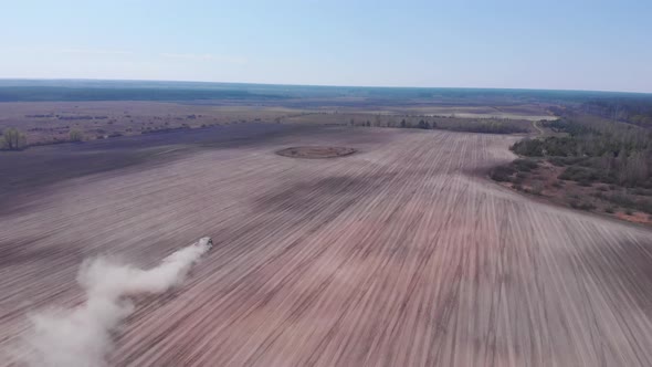 Farm tractor plowing land, preparing for crops. Agriculture concept.