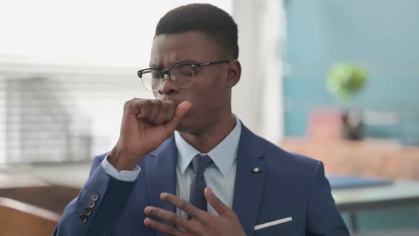 Sick Young African Businessman Coughing