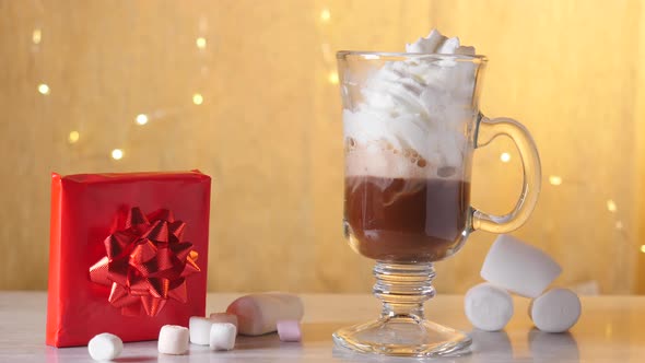 Preparing Hot Chocolate with Cream and Marshmallows