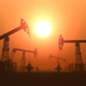 Working Oil Pump Jacks in a Desert Against Sunset Extracting Crude Oil - VideoHive Item for Sale