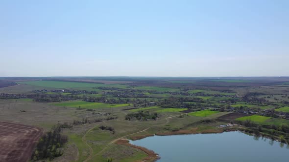 Countryside panorama. Small houses near a pond.