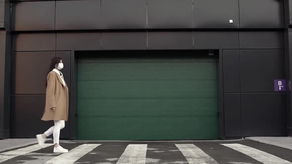 Girl in White Viral Mask Walking on a Crosswalk