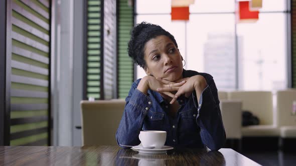 Tired Young African American Woman is Sitting in Mall Cafe After Exhausting Shopping