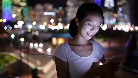 Woman use cellphone at night