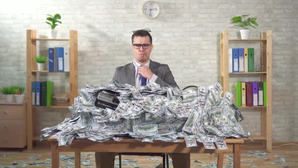Portrait Serious Man Businessman in a Pile of Banknotes Looks at the Camera