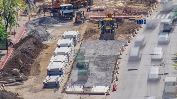 Green Vibration Roller Compactor Rolls on a Stones at Road Construction and Repairing Timelapse