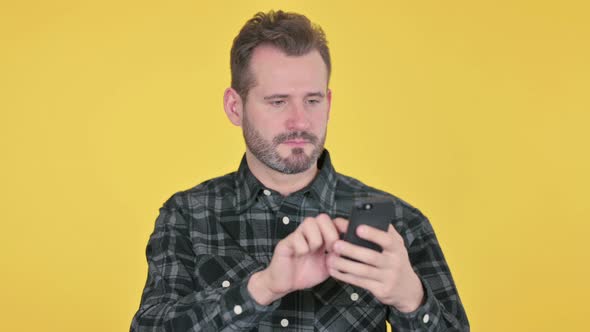 Portrait of Middle Aged Man Using Smartphone