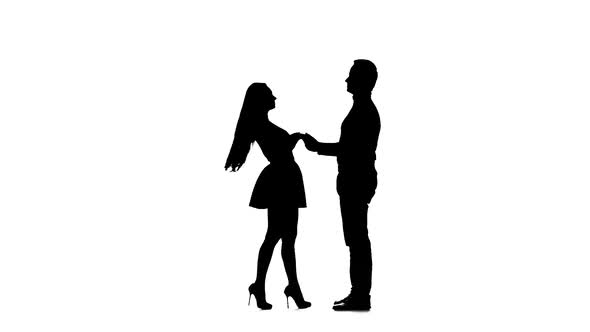 Guy Takes the Girl in His Arms and Kisses. Silhouette. White Background. Slow Motion