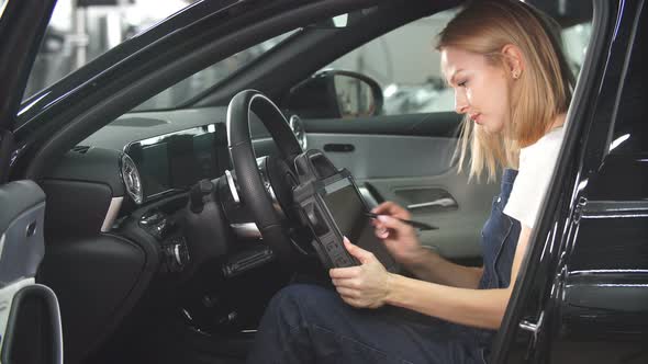 Mechanic Woman with Automotive Diagnostic Scanner